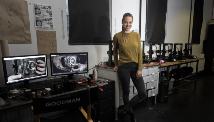 Dora Goodman alongside Anycubic i3 Mega printers in her workshop.