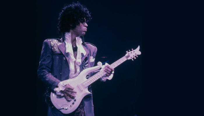 Prince playing Cloud guitar on stage