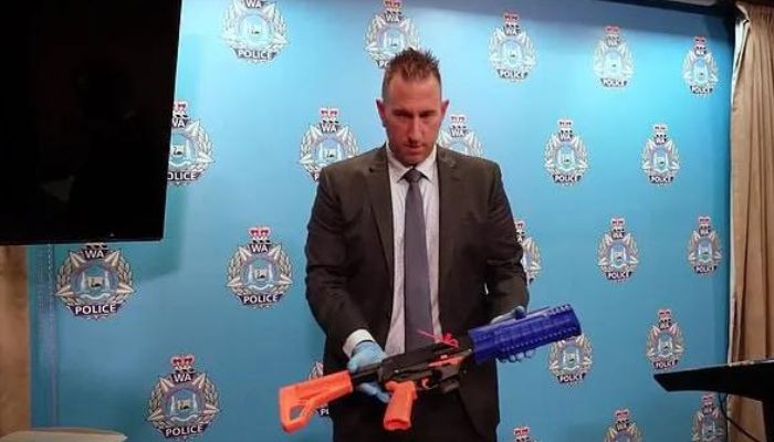 Police officer holding a 3D-printed gun