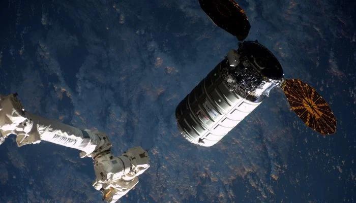The Cygnus cargo ship in outer space.