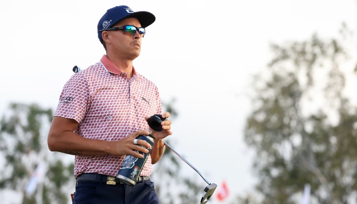 Mid-shot of Pro golfer Rickie Fowler as he assesses the golf course.