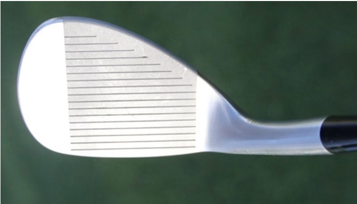 Close-up of Rickie Fowler's new Cobra Golf wedge at address.