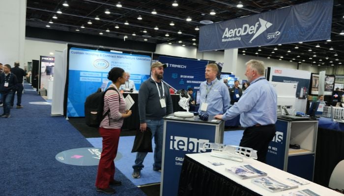 Some of the AeroDef exhibitors on the show floor at RAPID + TCT 2025
