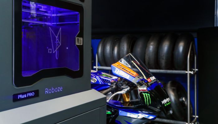 Yamaha motorcycle pictured next to Roboze 3D printer